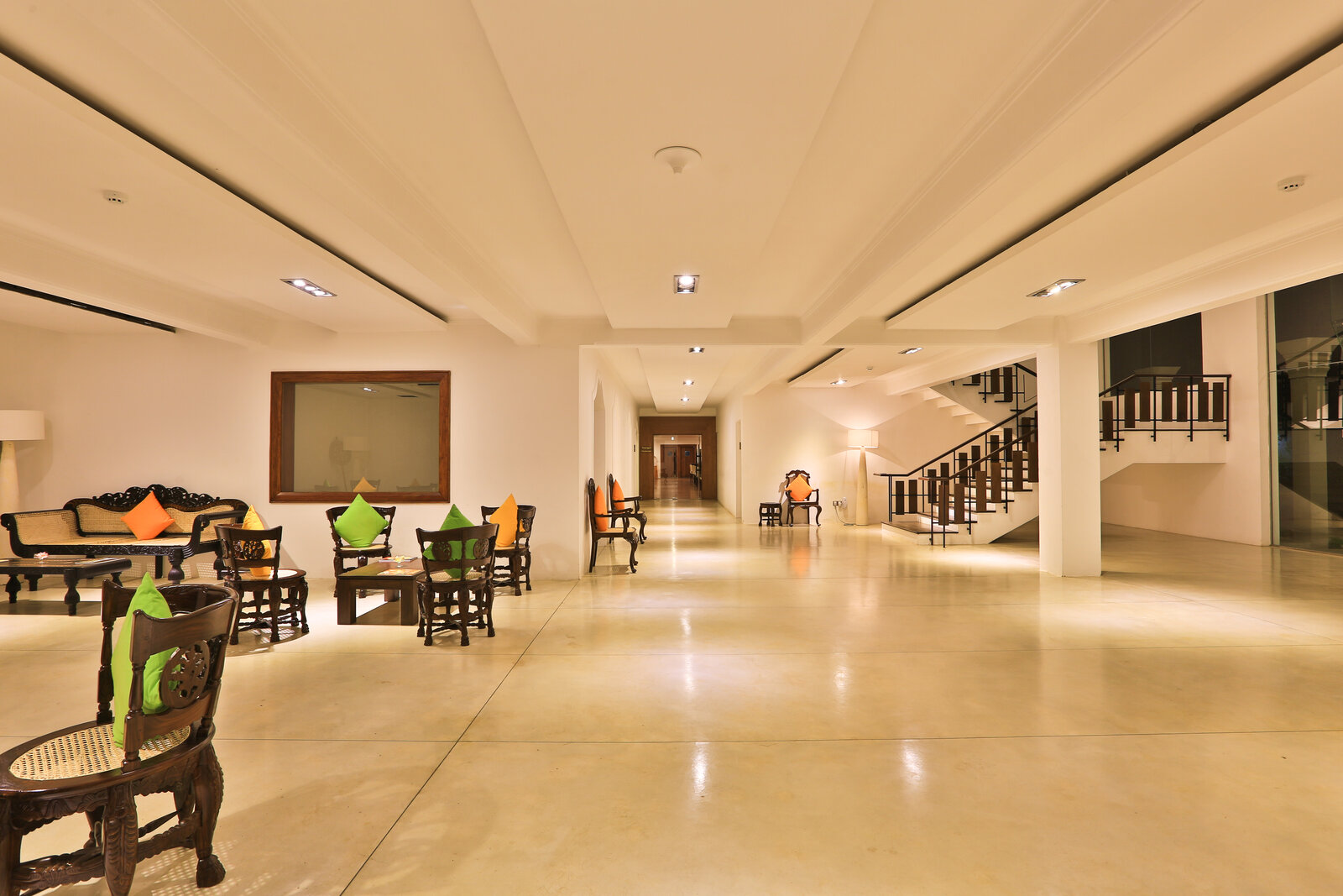 Rajarata Hotel main lobby with carved wooden chairs and staircase